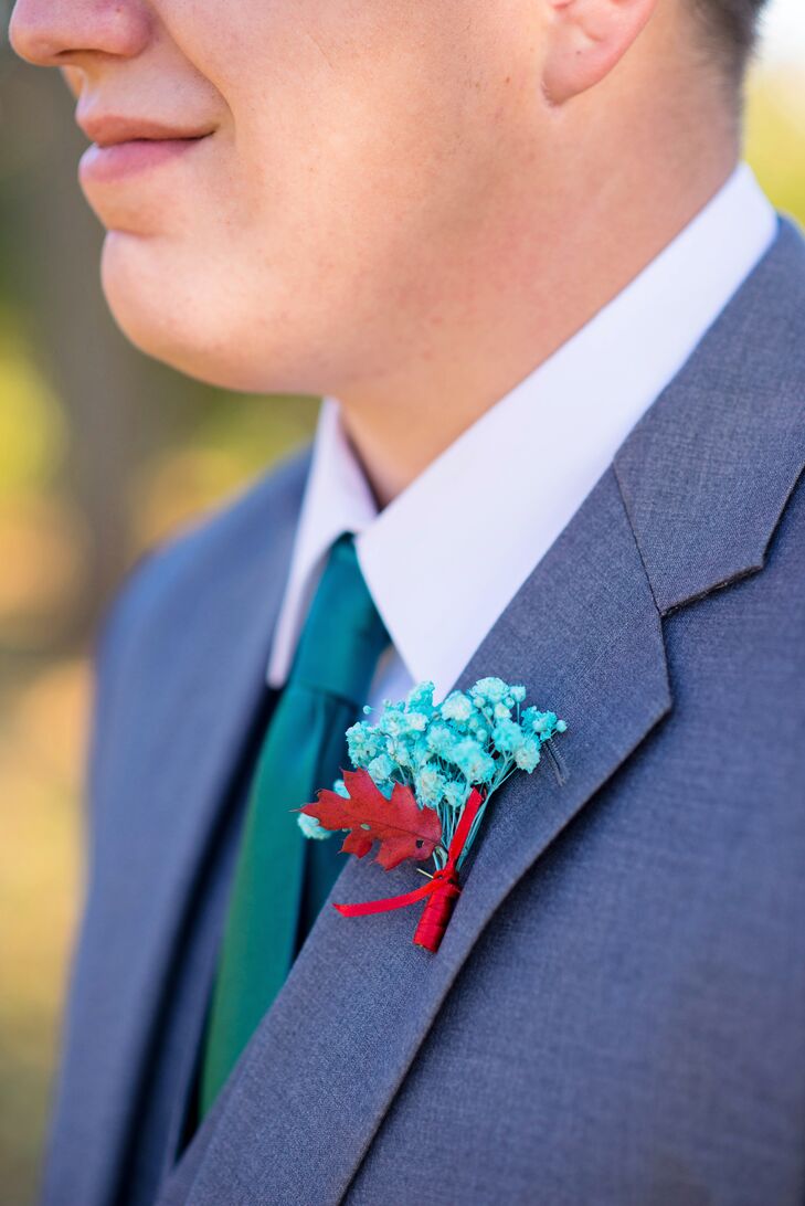 The groom and his groomsmen wore matching teal and red boutonnieres to go with their gray fashions and teal ties. The bridesmaids wore red pin-up-inspired peep-toes for a pop of color to complement the men's flowers.