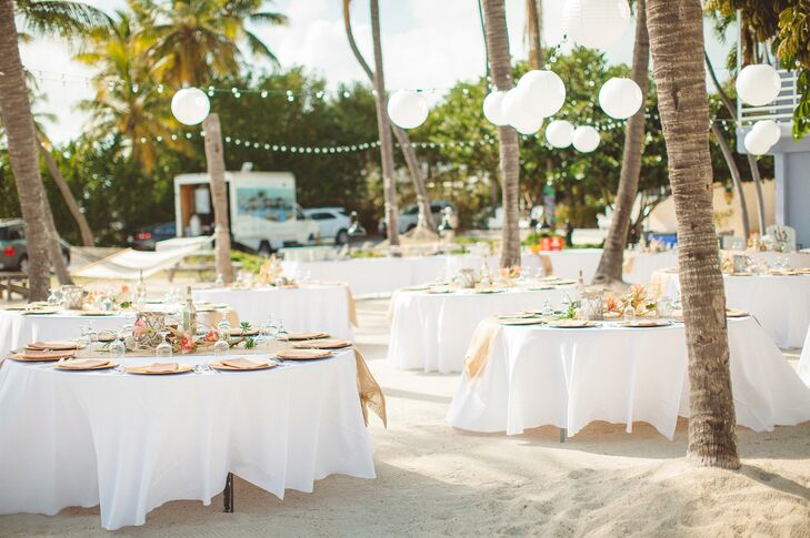 The reception took place on the beach at the Drop Anchor Resort. Guests enjoyed an alfresco dinner of local specialties under the stars. Strands of bistro lights hung over the space, filling the beach with warm, ambient light as the sun set over the water. rn
