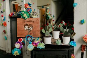 Wood Welcome Sign with Bright Paper Flowers and Cacti