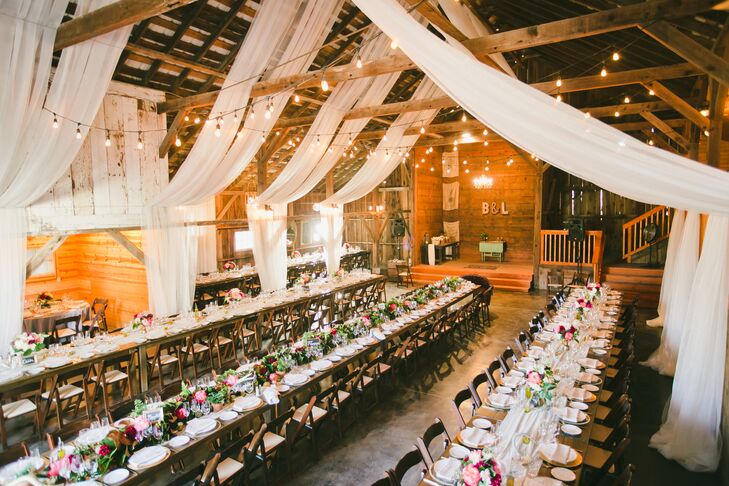 Inside the rustic barn at Olympia's Valley Estate in Petaluma, California, the high ceiling had wooden beams with white linens and string lights draped over the wooden dining tables. The reception decor truly fit the rustic-glam, romantic vibe that continued throughout the day.