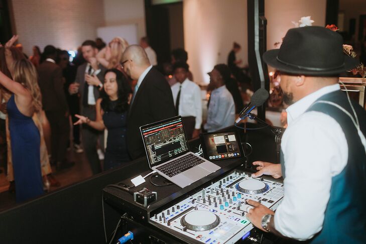Wedding DJ Performing While Guests Dance on the Dance Floor