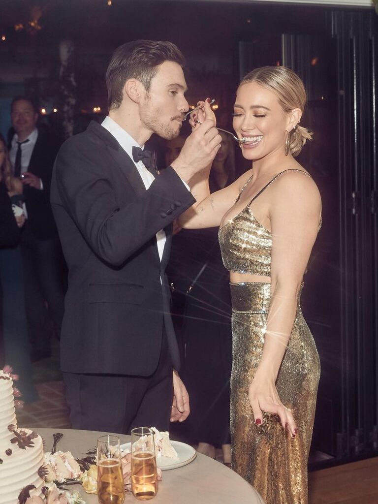 Hilary Duff wears a glittering gold gown at her wedding reception. 