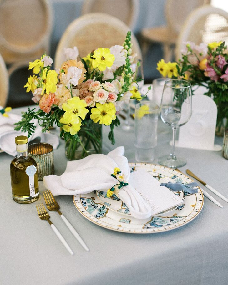 Blue-and-White Charger Plates, Blue Linen and Low Bright Centerpiece With Lemon Napkin Ring