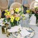 Blue-and-White Charger Plates, Blue Linen and Low Bright Centerpiece With Lemon Napkin Ring