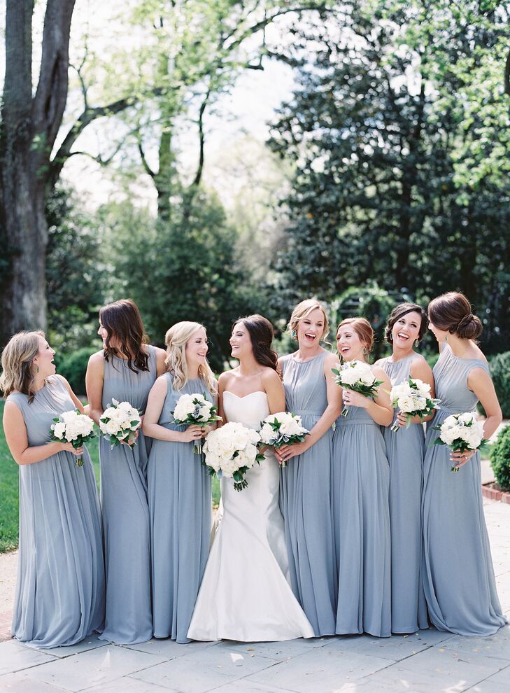 The bridesmaids were dressed in light-gray Jenny Yoo dresses with an illusion neckline. Nina gave each her bridesmaids a pair of emerald Kendra Scott “Elle” earrings as a thank-you for being a part of her big day. “I loved that their dresses and earrings were some of the few pops of color,” she says.