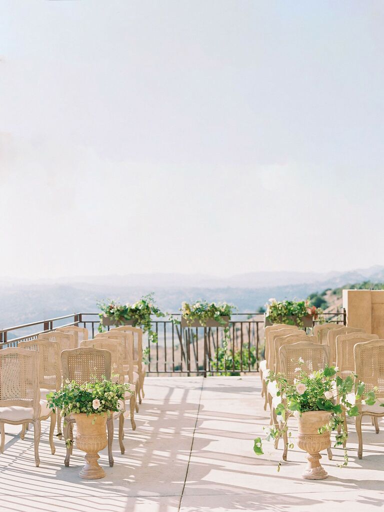 Minimal floral ceremony aisle decorations at outdoor summer wedding