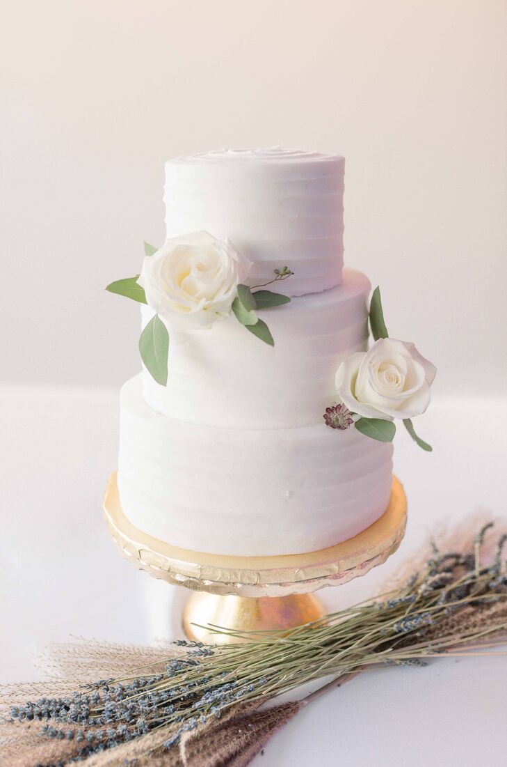 Simple Three-Tier White Wedding Cake With White Roses on Gold Cake Stand