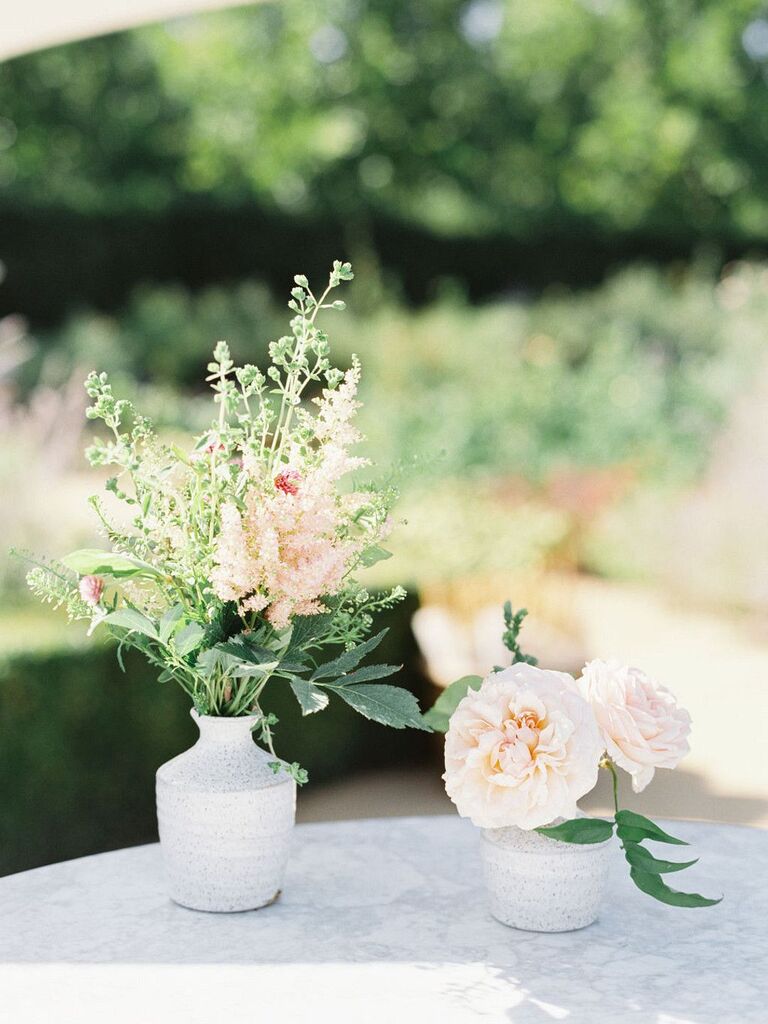 Petite gray bud vases with greenery and pink flowers