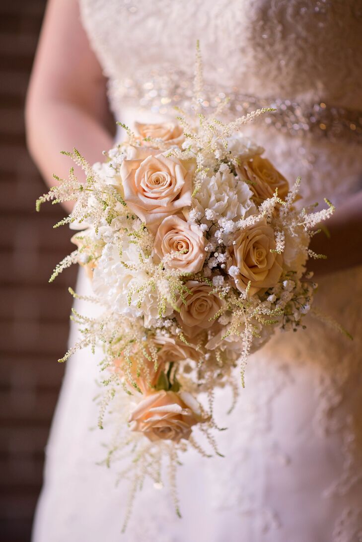 Leah carried a beautiful textured bouquet of cascading ivory roses that looked almost antique, befitting her vintage wedding theme. When she could not wear her grandmother's wedding dress, she took a swatch of the gown to tie around her flowers.
