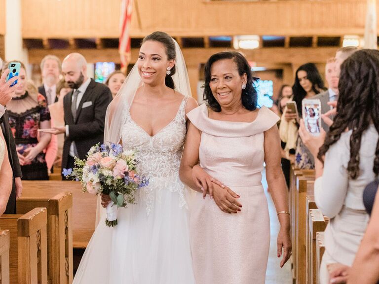 Bride walking down the aisle with mother