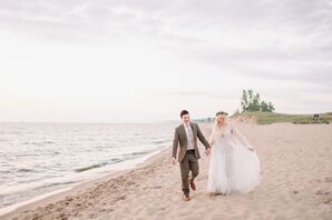 Couple Holding Hands and Walking Along Beach at Lake Michigan