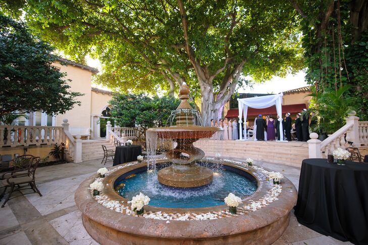For their floating courtyard and indoor cocktail hour, Dalsimer Atlas accented the Addison's fountain with sweet white rose petals in between low arrangements of white roses and hydrangeas. A saxophonist played in the background as their guests enjoyed passed hors d’oeuvres and Hawaiian signature drinks inspired by the couple's honeymoon spot.