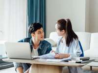 Young couple wedding planning on laptop at home