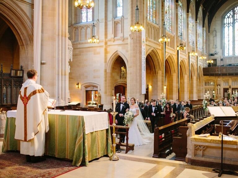 Priest speaking to couple at Catholic wedding ceremony