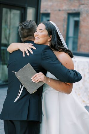 Bride in Long Veil, Drop Earrings Embracing Groom With Vow Book