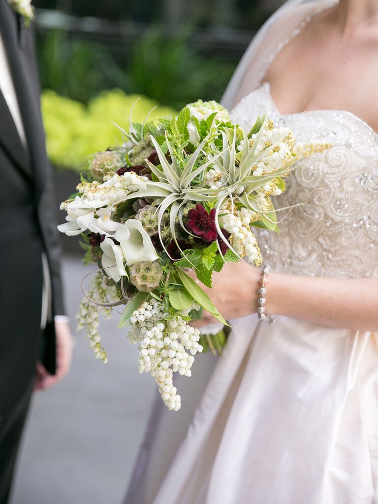 elegant classic fall wedding bouquet with air plant, calla lilies, pieris and red scabiosa