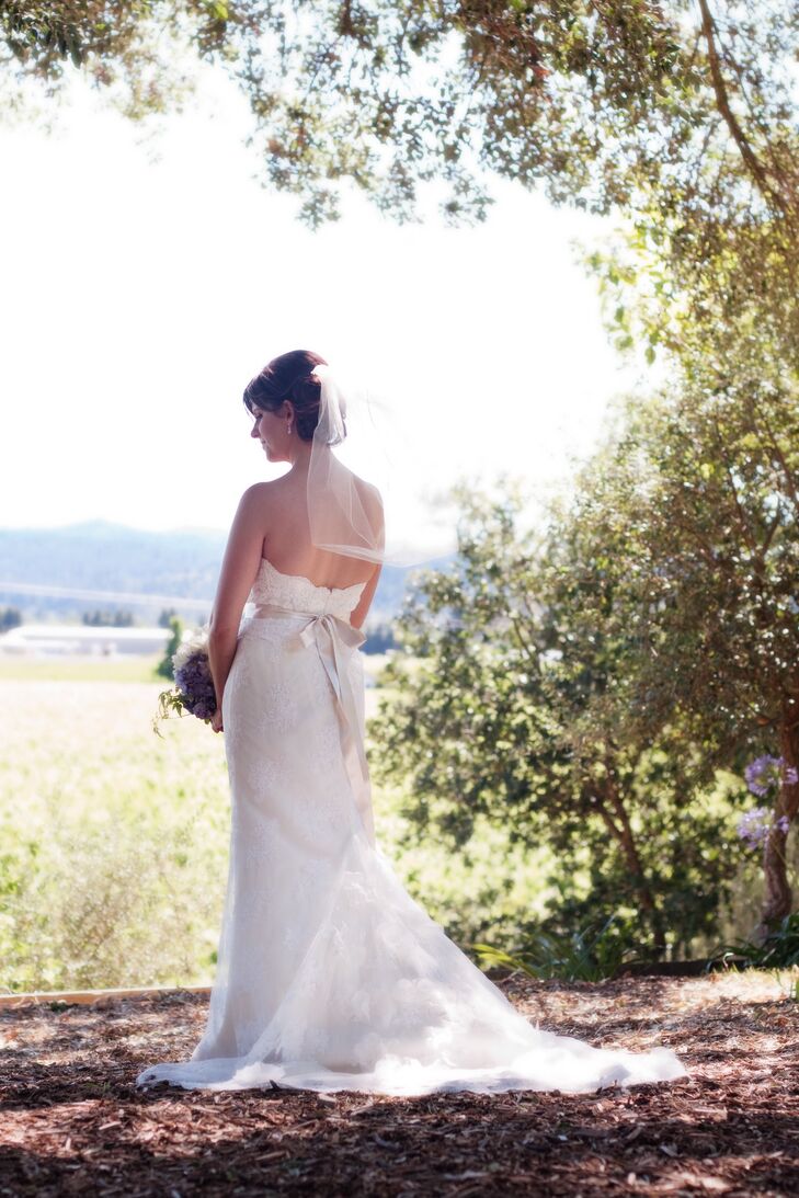 Jen's dress was elegant and romantic with delicate lace and a satin crystal-embellished ribbon. The elbow-length veil added a traditional touch to her look.