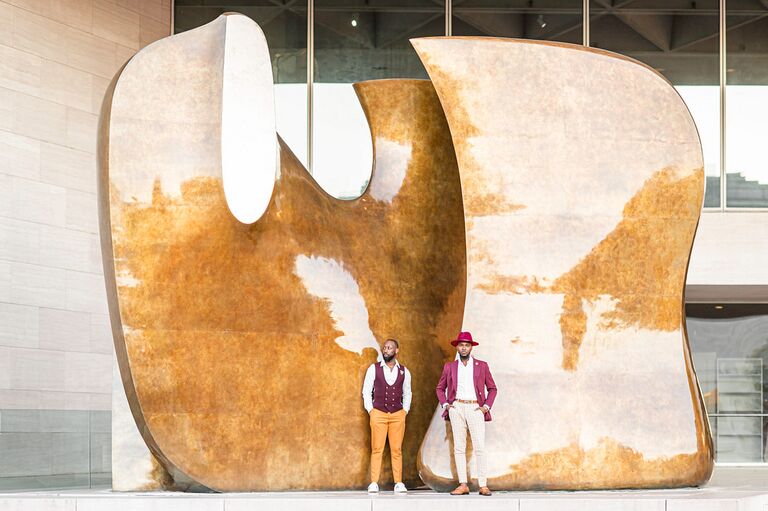 Couple poses in front of art installation