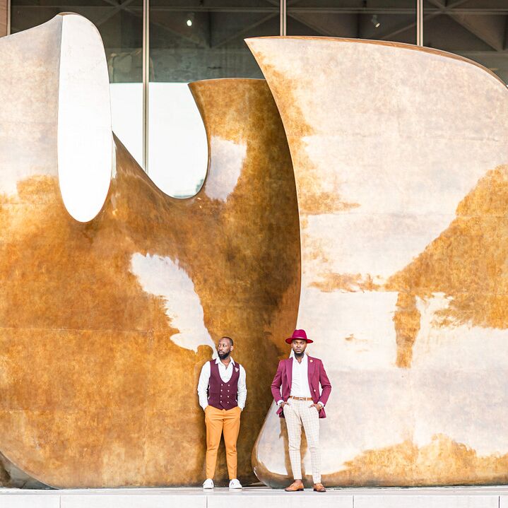 Couple poses in front of art installation
