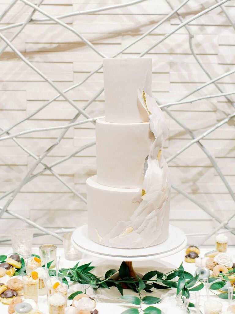 Modern white three-tier cake with wave-inspired decoration