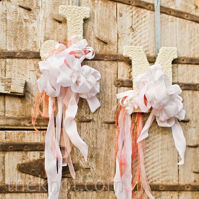 To give consistency to the weekend’s events, Megan and Jeff introduced the color scheme at the rehearsal dinner: They hung letters of their monogram and softened them up with sweet pink and white ribbons.