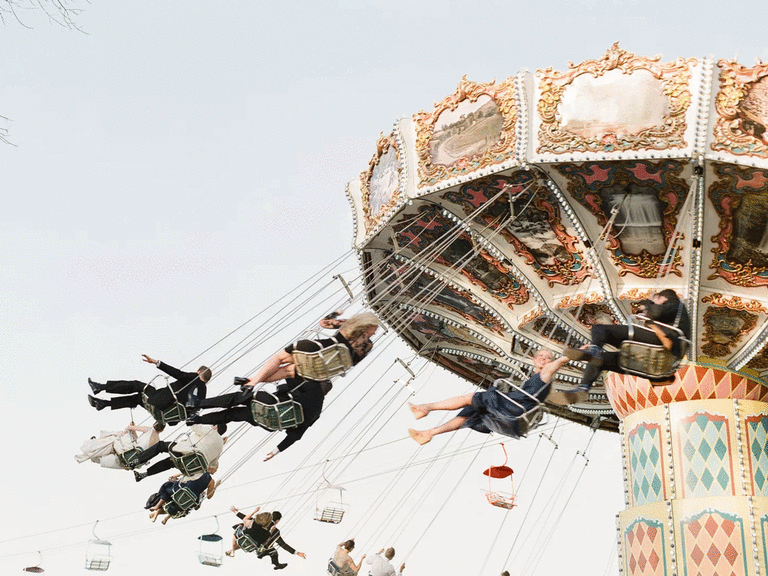 Wedding guests riding wave swinger amusement ride as a wedding reception entertainment idea.