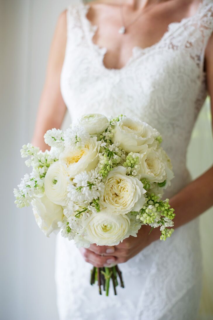 Lush garden roses and ranunculus gave Emily’s bridal bouquet a classic, romantic feel, and clusters of bright white lilacs captured the vitality of spring and added a light fragrance to the arrangement.
