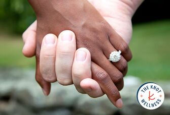 couple holding hands engagement ring
