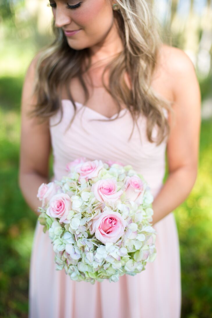 The bridesmaids carried green hydrangeas and blush roses in their bouquets.