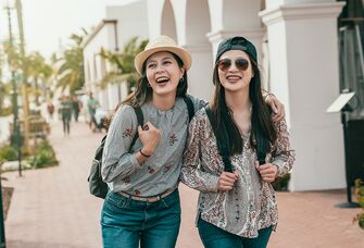 two young women walking down a street in santa barabara california