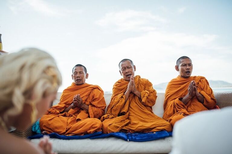 Monks praying during traditional Thai wedding