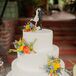 The three-tier white wedding cake had accents of colorful blooms used throughout the day. The classic dessert had a topper depicting a bride and a groom, fitting the occasion perfectly.