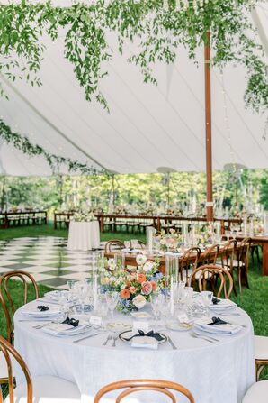 Round Table With White Linen, Pastel Flowers Under Tent Overlooking Black-and-White Dance Floor