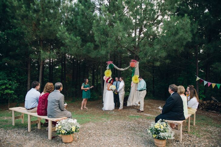 Jared's brother, Christopher, who introduced Namia and Jared, officiated their intimate outdoor wedding ceremony. The wedding arch had red, green and yellow flowers on draped neutral fabric to tie in to the color theme, and guests sat on picnic benches.