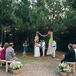 Jared's brother, Christopher, who introduced Namia and Jared, officiated their intimate outdoor wedding ceremony. The wedding arch had red, green and yellow flowers on draped neutral fabric to tie in to the color theme, and guests sat on picnic benches.