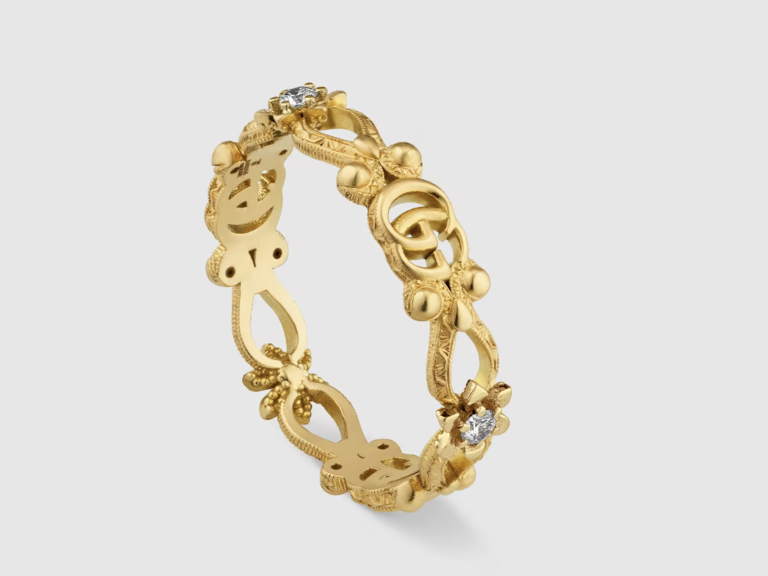 gold band with gucci symbol and diamonds
