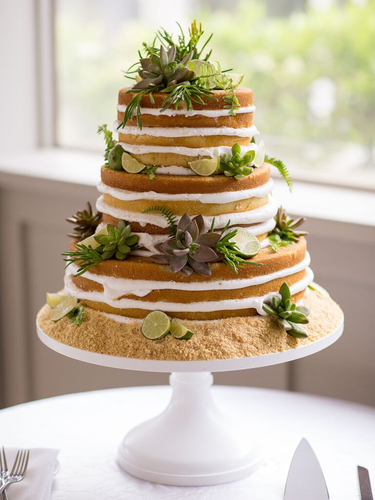 key lime pie naked wedding cake with graham cracker crumb base, succulents and sliced limes