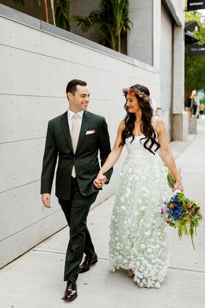 Bride and Groom in Wedding Attire With Touches of Green