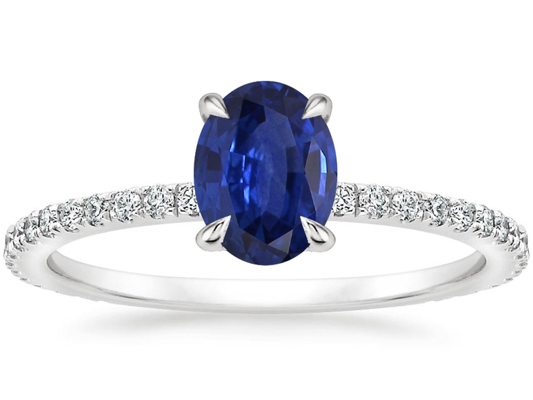 A silver band with small diamonds and an oval-shaped sapphire.