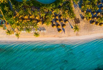 The sun peaks over the dunes at Playa del Carmen, Mexico.