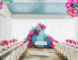 colorful hot pink and turquoise balloon backdrop at ballroom bridal shower