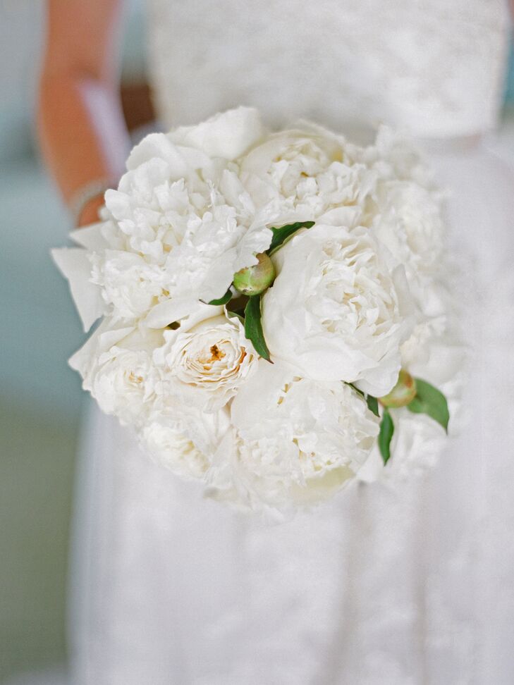 Margot carried a bouquet of ivory peonies arranged by Botonica.