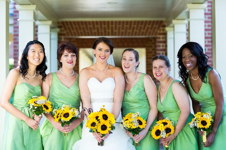 The bridesmaids wore "appletini" green dresses in different styles by Alfred Sung. They carried small bouquets of sunflowers and baby's breath.