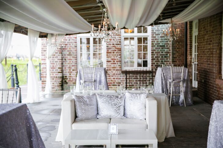 After the couple said their "I do's" they joined their guests on the Historic Rice Mill's patio for cocktail hour, where guests sipped on signature cocktails like Elderflower Old Fashioneds and St. Germaine, Hendricks and soda and took in views of the Charleston waterfront. Silver sequined table linens and metallic accents paired with sleek, modern lounge furniture to inject the open-air space with a festive, glamorous vibe.