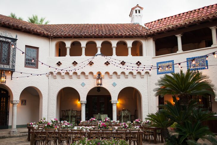 Alicia and Ian outfitted their alfresco dinner reception with long wooden tables and romantic bistro lights.