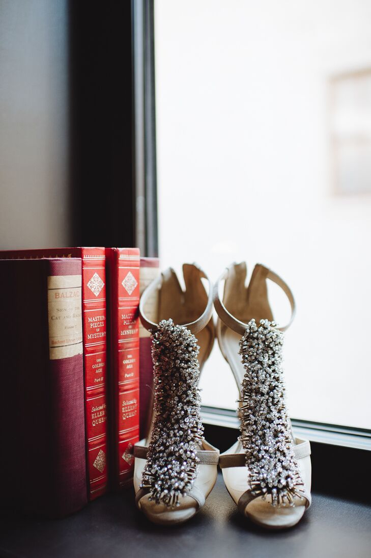 While Whitney’s Monique Lhuillier gown was stunning on its own, the bride took the glam factor to the next level with a pair of strappy bead-embellished heels that played up the embroidered details on her dress. To complete the look, she wore a pair of crystal ear jackets for an extra hint of glitz.