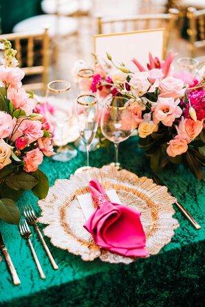 Place Setting With Gold Charger, Pink Napkin and Flowers and Green Linen