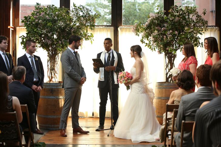 Emma and Jesse kicked off the celebrations with a ceremony in the Atrium, in which they exchanged heartfelt vows they’d written themselves and excerpts from Shakespeare’s “Sonnet 116” and Charlotte Bronte’s “Jane Eyre” were read. As an extra special touch, Emma and Jesse asked their close friend Zenith Richards to officiate. Playing up the venue, wine barrels topped topped with lush floral arrangements framed the couple as they said their “I do’s” and lush green garlands were placed along the length of the aisle.