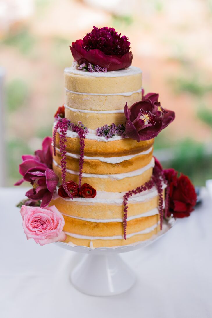 The couple enlisted the talents of their family members and friends to give the day a personalized feel. Lindsay’s mother baked the wedding cake in her kitchen in Kansas, froze the layers and drove them to Colorado, where she thawed and assembled them with buttercream frosting. Lindsay and her mother then dressed up the naked cake with rich purple, pink and red blooms for dramatic effect.