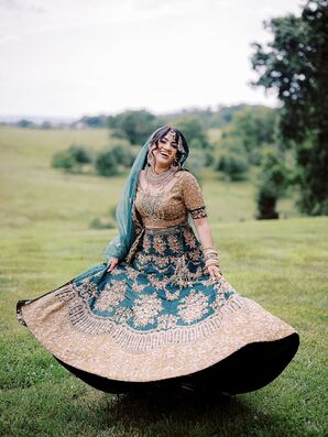 Bride Twirling With Joy in Emerald and Gold Lehenga